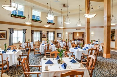 Bright dining room with tables set for meals