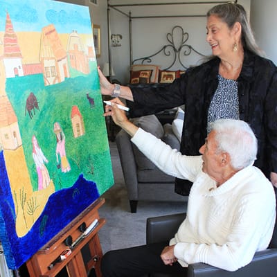 Residents engaging in art activity in a cozy room