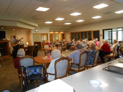 Residents enjoying a live music performance in a common area