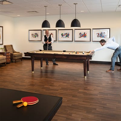 Residents engaging in a recreational activity in a lounge