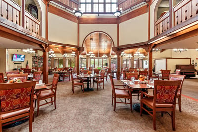 Brightly lit dining room with tables set for meals