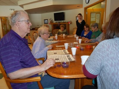 Residents engaging in a bingo game around a table