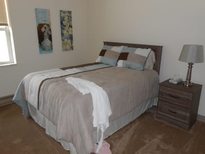 Cozy bedroom with soft bedding and artwork