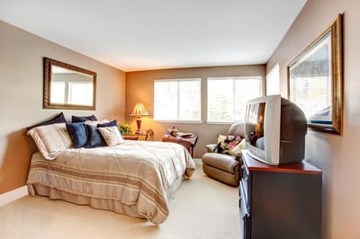 A cozy resident room with a bed and seating area