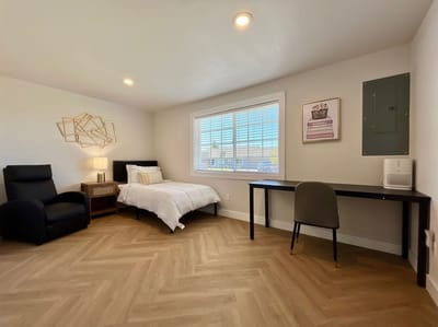 A well-lit, furnished private room in a care facility