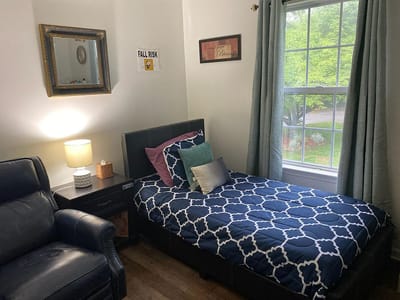 Cozy resident room with bedding and seating area