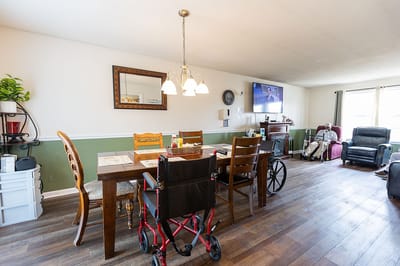 Interior dining area with residents and meal setup