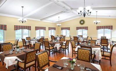 Dining room setup with tables and decorative flowers