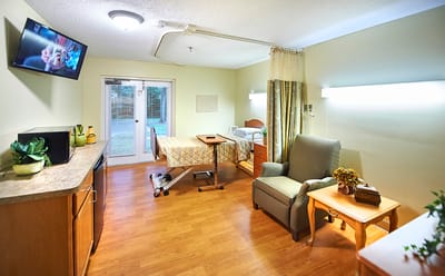 Comfortable private resident room with a bed and seating area