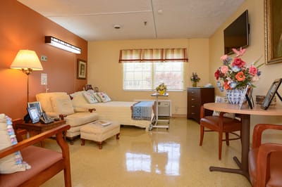 A cozy resident room with sunlight and colorful decor