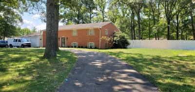 Exterior view of a senior living facility surrounded by trees