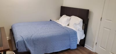 Private bedroom with a blue bedspread