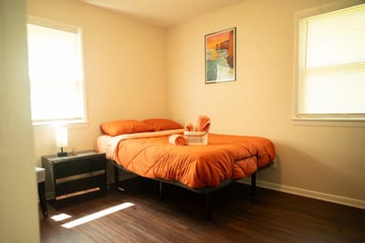 Cozy private resident room with orange bedding