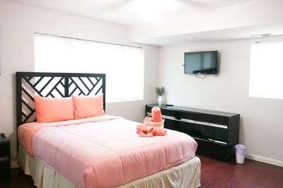 Cozy private resident room with pink bedding and TV