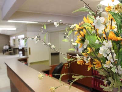 A flower arrangement on the reception desk in a facility lobby