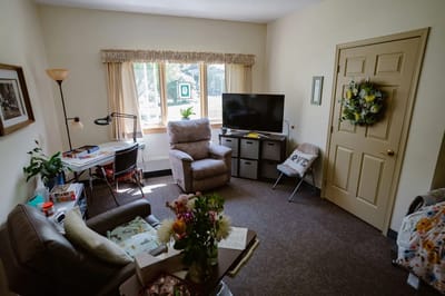 Cozy resident room with a comfortable chair and desk