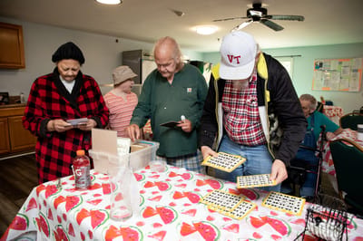 Residents playing bingo in an activity room