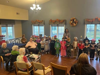 Residents enjoying a Halloween event with children in costumes