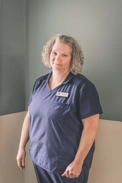 Staff member posing in an interior space of the facility