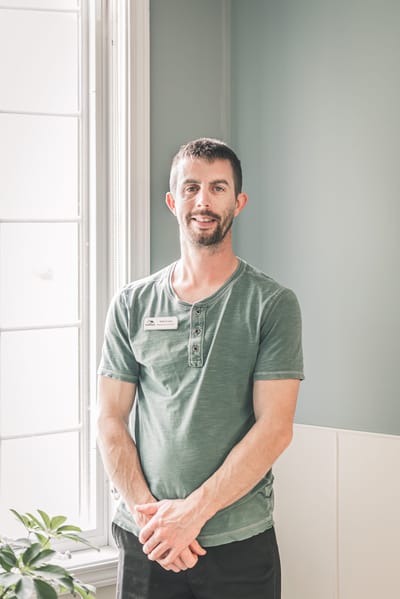Staff member posing in a well-lit interior space
