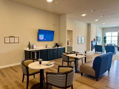 Common area with seating and a TV in the background