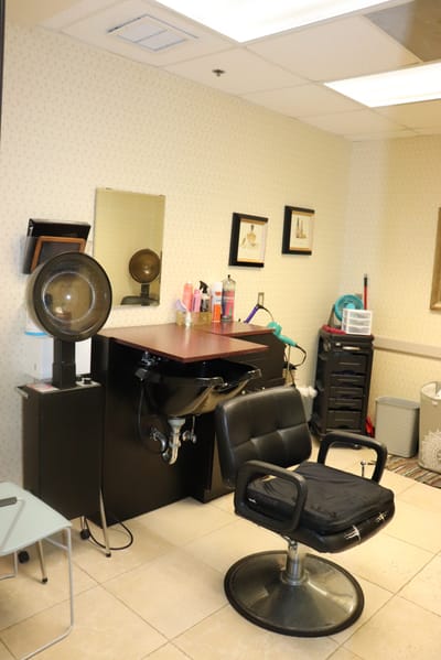 Interior of a salon room with styling chair and equipment