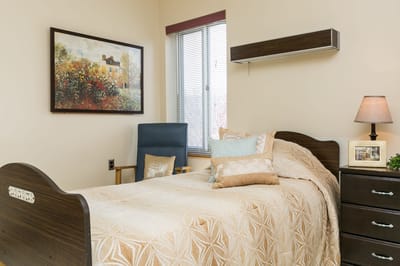 Cozy resident room with a bed and chair