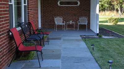 Patio seating area with chairs and stone pathway