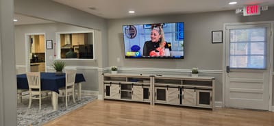 Interior dining area with residents watching TV