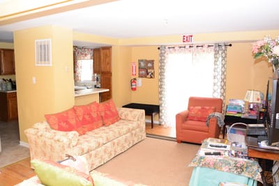 Bright common area with sofas and a television.