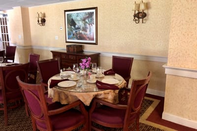 Dining area with a set table and floral decoration