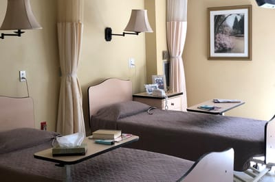 A shared resident room with two beds and decor