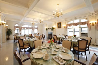 Dining room set for a meal with elegant table settings