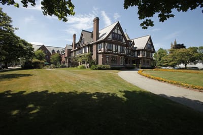 Exterior view of a senior living facility surrounded by lawns