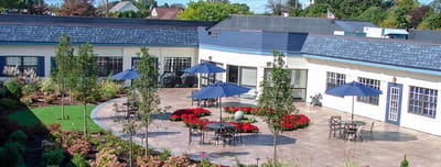 Outdoor patio area with seating and landscaped gardens