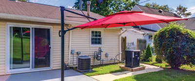 Outdoor space with a red umbrella and greenery