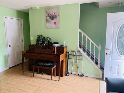 A shared social space with a piano and seating