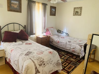 A cozy interior of a resident room with two beds