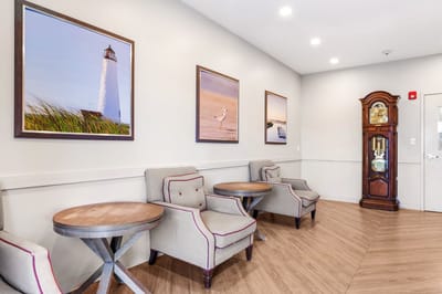 A cozy common area with seating and wall art