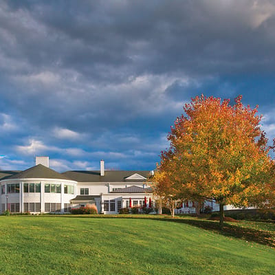 Exterior view of a senior care facility surrounded by trees