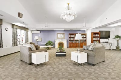 Common area with comfortable seating and bookshelf