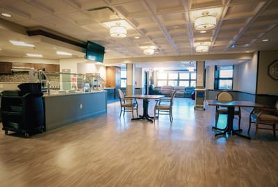 Interior view of a bright common area with tables and chairs