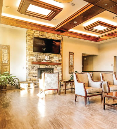 Bright common area with comfortable seating and a fireplace