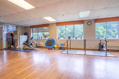 Interior fitness area with exercise equipment and windows