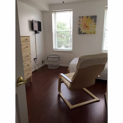 Cozy resident room with a chair and dresser