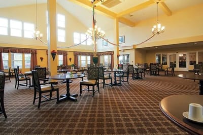 Bright dining room with table settings and chairs