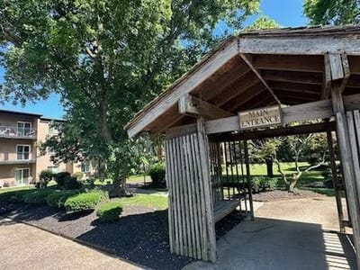 Main entrance of Sycamores Terrace with a wooden shelter