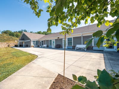 Exterior view of assisted living facility with outdoor seating