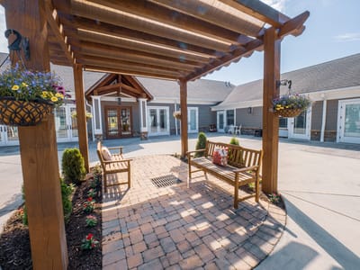 Beautiful outdoor seating area with a pergola and flowers