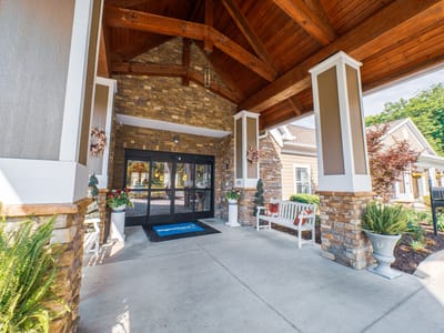 Entrance of a senior living facility with a wooden roof